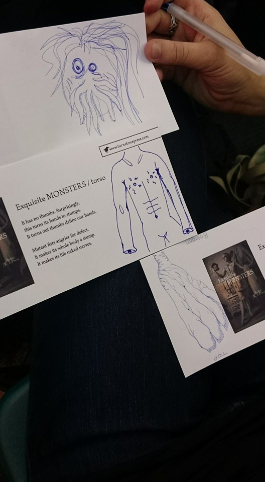 a hand holding three cards with monster parts drawn on them. The middle one also has a poem.