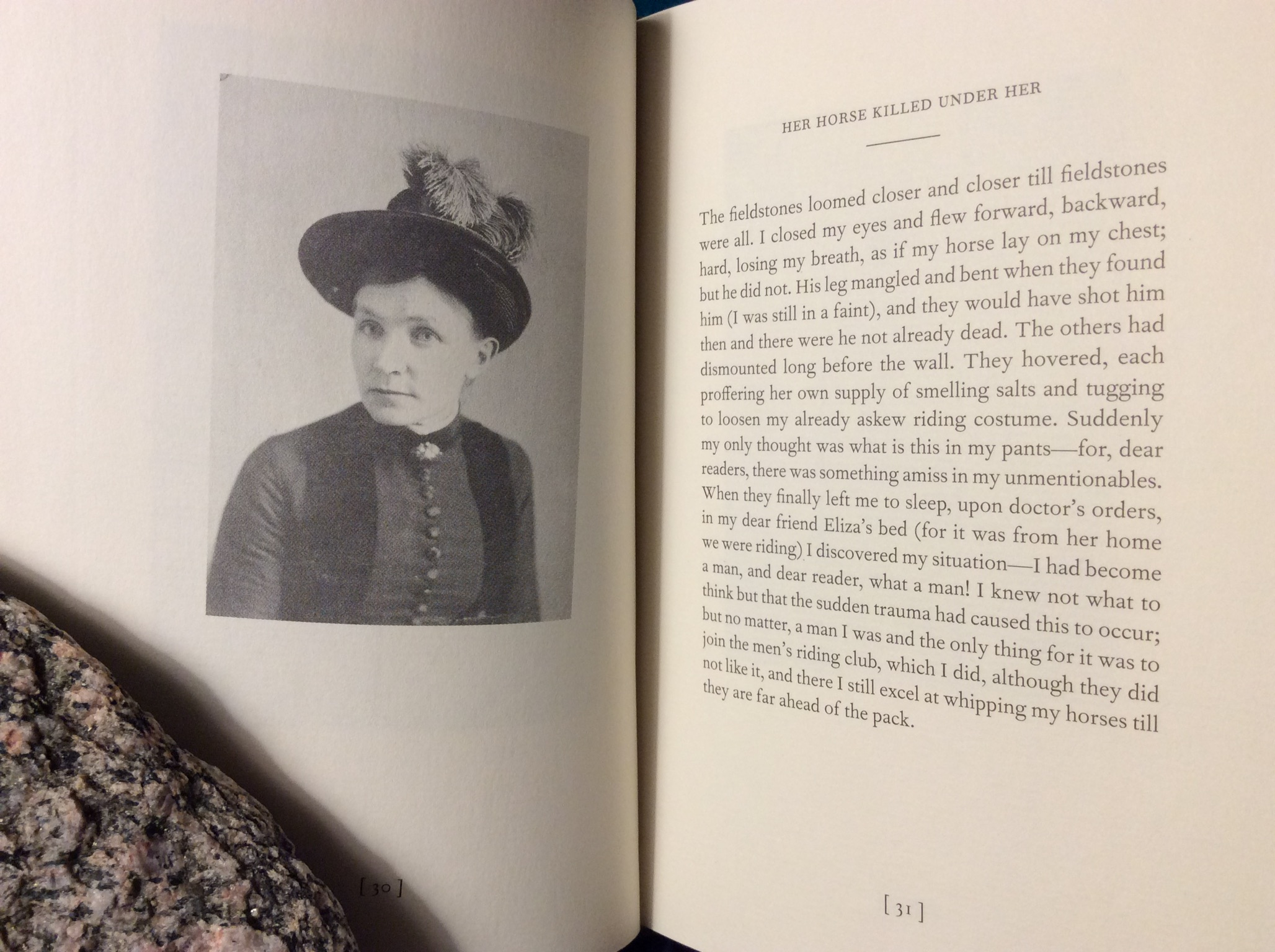 Book Types of Canadian Women open to a spread of a  vintage photo of a woman in a hat on one side, and a blocky prose poem on the right.