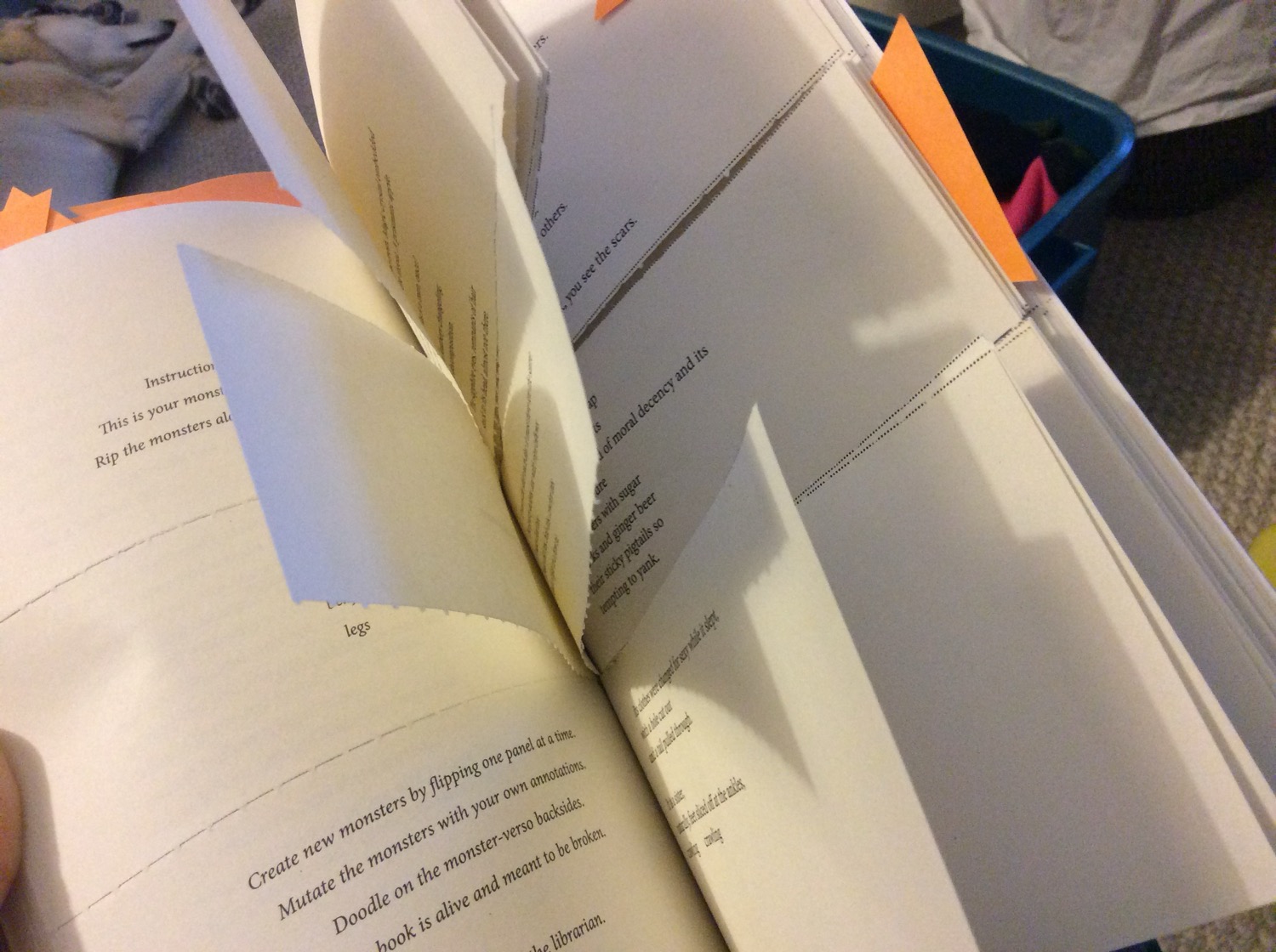 A book open to pages that have been cut into thirds horizontally.