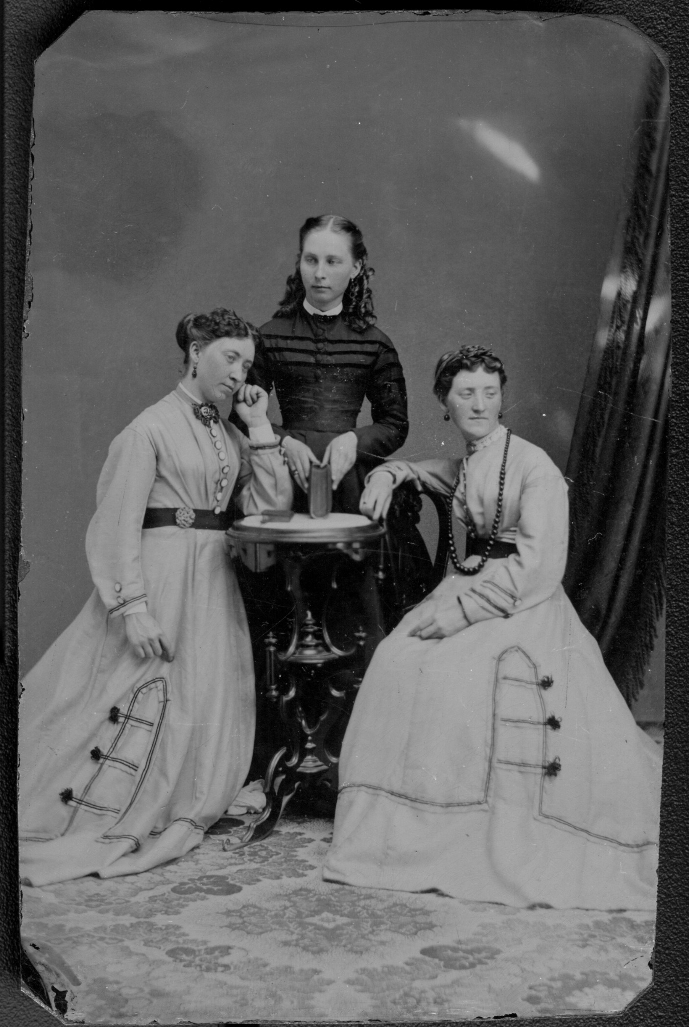 vintage photograph of three women, two of whom look like twins